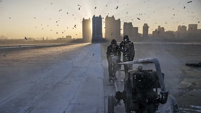 Chinese workers use a machine to cut into large blocks of ice that will be used in the making of ice sculptures from the frozen Songhua River in preparation for the Harbin Ice and Snow Festival in Harbin, China. Getty Images