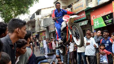 Kalpesh Modi performs with his motorcycle as he rehearses for the forthcoming annual procession 'Rath Yatra' in Ahmedabad, India. Sam Panthaky / AFP