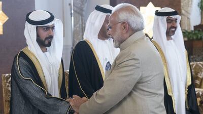 ABU DHABI, UNITED ARAB EMIRATES - February 10, 2018: HH Sheikh Khalifa bin Tahnoon bin Mohamed Al Nahyan, Director of the Martyrs' Families' Affairs Office of the Abu Dhabi Crown Prince Court (L), receives HE Narendra Modi Prime Minister of India (R), at the Presidential Airport. ( Rashed Al Mansoori / Crown Prince Court - Abu Dhabi ) ---