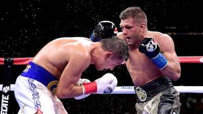 Sergiy Derevyanchenko punches Gennady Golovkin. AFP
