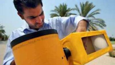 Sabu Damodharan, a technician at the Sharjah Science Museum, adjusts a reflective telescope used for safe viewing of an eclipse.
