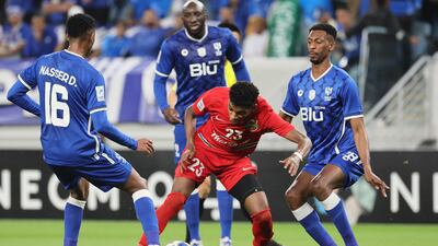 Shabab Al Ahli's Yahya Al Ghassani, centre, is surrounded by Al Hilal players.