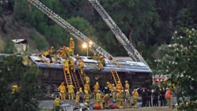 Firefighters work to rescue trapped passengers at the site of a train crash where a MetroLink commuter train collided with a freight train in the Chatsworth area of Los Angeles on Sept 12 2008.
