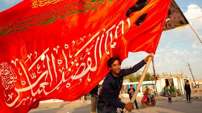 An Iraqi demonstrator waves a religious flag during an anti-government demonstration in the southern city of Basra. AFP