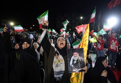 People wave Iranian and Hezbollah flags at a rally in Tehran on June 7 following Iran's attack on Israel. EPA