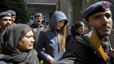 Pakistani model, Ayaan Ali, centre, arrives in tight security to appear in a court in Rawalpindi, Pakistan. Ali is under detention since her midnight arrest at Islamabad airport and now faces money laundering charges after authorities seized over $500,000 before she boarded a Dubai-bound flight. B.K. Bangash / AP Photo