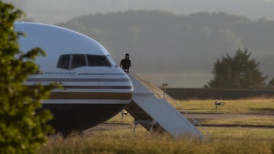 A man stands on the steps of the grounded Rwanda deportation flight EC-LZO Boeing 767 at Boscombe Down Air Base, in June 2022. The flight taking asylum seekers from the UK to Rwanda was grounded at the last minute after the intervention of the European Court of Human Rights