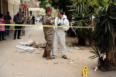 Lebanese Army investigators outside a building where clashes erupted between Lebanese troops and a former member of ISIS, who had engaged in an hours-long shootout with the security forces, in Tripoli, Lebanon, Tuesday, June 4, 2019. AP