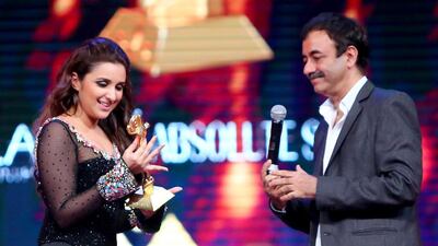 Indian actress Indian actress Parineeti Chopra holds her “Arab Youth Icon Female” award next to Indian film director Rajkumar Hirani. AFP PHOTO / MARWAN NAAMANI