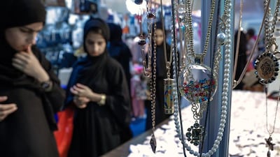 Visitors peruse a jewellery stall at the Eid fair in Fujairah. Victor Besa for The National