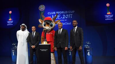 From left to right, Abdulrahim Jumaa, Ivan Cordoba, Mikael Silvestre and Eric Abidal pose for a photo with Dhabi the tournament mascot.