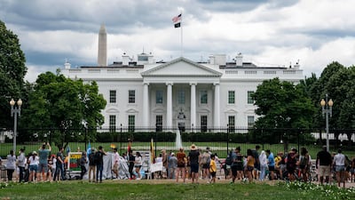 Visitors take photo of the White House on July 3, 2021 in Washington, DC. - Washington, DC prepares to host the annual Independence Day fireworks display on the National Mall on July 4 as the country recovers from the COVID-19 pandemic (Photo by ALEX EDELMAN / AFP)