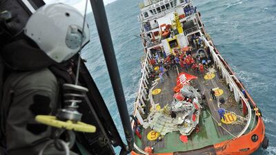 A portion of the tail of AirAsia Flight 8501 is seen on the deck of a rescue ship after it was recovered from the sea floor on the Java Sea. Prasetyo Utomo / AP