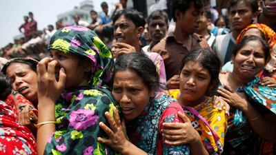 People mourn for their relatives, who are trapped inside the rubble of the collapsed Rana Plaza building. Reuters / Andrew Biraj