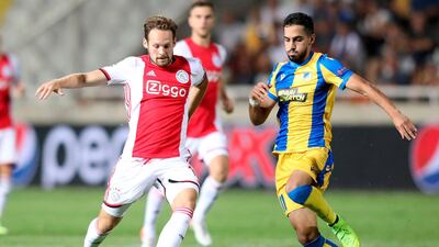 Ajax defender defender Daley Blind vies for the ball with APOEL midfielder Musa Suliman. AFP