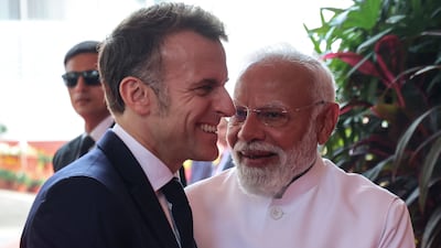 French President Emmanuel Macron, left, is welcomed by Indian Prime Minister Narendra Modi in Mumbai. AFP