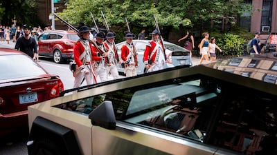 Re-enactors march past a Tesla Cybertruck as they parade down Third Avenue, as part of an event to mark the 250th anniversary of the Battle of Brooklyn, in New York. Reuters