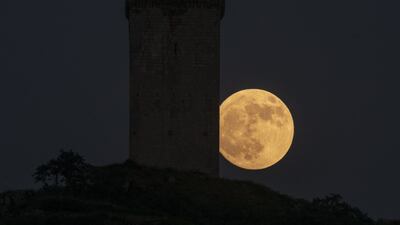 The last full moon of this spring, also known as 'the strawberry moon, is visable next to Da Pena Tower, in Xinzo de Limia, northern Spain. EPA