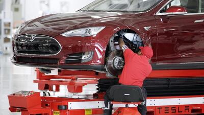 A worker at a Tesla factory. The car maker is leaning heavily towards automation, a trend identified by recent studies as a major reason for job losses in the US. Paul Sakuma / AP Photo