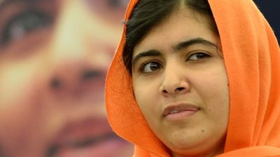 Malala Yousafzai, left, the Pakistani teenager who was shot in the head by the Pakistani Taliban. Patrick Hertzog / AFP