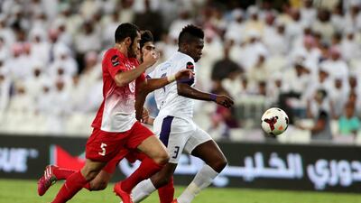 Al Ain's Asamoah Gyan, right, fights for the ball with Al Jazira's Musallem Fayez, No 5, and Ismail Mohammed Al Jasmi during their Arabian Gulf League match at Hazza bin Zayed stadium in Al Ain on May 1, 2014. Christopher Pike / The National