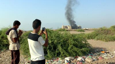 Yemenis film smoke rising from the Qasr Hotel in Aden after it was hit by an attack claimed by ISIL on October 6 Aden. EPA