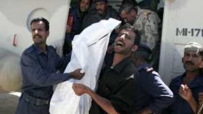 The body of one of three foreigners killed by kidnappers is unloaded from a military helicopter in Sana'a, Yemen, yesterday.