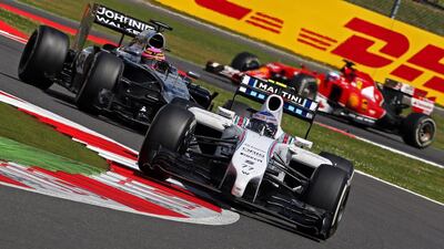 Finnish driver Valtteri Bottas of Williams, front, steers his car ahead of British driver Jenson Button of McLaren-Mercedes during the British Grand Prix at Silverstone on July 6, 2014. Geoff Caddick / EPA