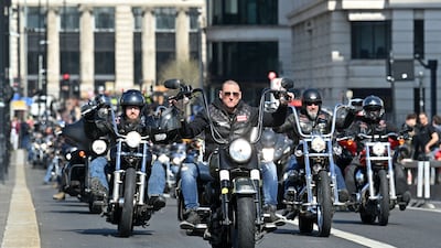 Members ride across London Bridge in March 2022. AFP