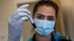 BIRMINGHAM, ENGLAND - JUNE 05: Jess Baddams, paramedic, holds a blood sample as she poses for a photograph during an antibody testing program at the Hollymore Ambulance Hub of the West Midlands Ambulance Service, operated by the West Midlands Ambulance Service NHS Foundation Trust, on June 5, 2020 in Birmingham, England. The British government is providing antibody testing to NHS and care home staff as part of the first phase of its antibody testing programme. The blood tests, which can only be performed my trained medical practitioners, detect the presence of antibodies to COVID-19 to determine if a person has unknowingly contracted the virus and consequently developed an immune response. (Photo by Simon Dawson - Pool/Getty Images)