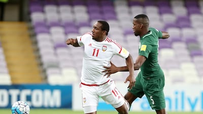 UAE's Ahmed Khalil, left. and Omar Ibrahim Othman of Saudi Arabia in action during their World Cup qualifier at Hazza bin Zayed Stadium on Tuesday. Chris Whiteoak / The National