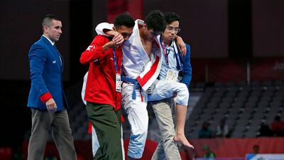 Khalid Iskander Al Balushi of the UAE is carried off the mat during the men’s 56kg gold medal match against fellow Emirati Hamad Nawad. Issei Kato / Reuters