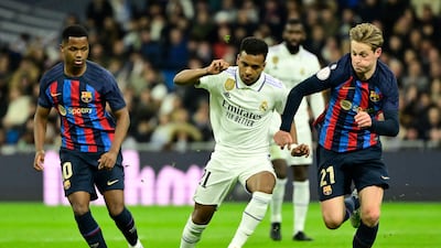 Real Madrid's Rodrygo fights for the ball with Barcelona's Ansu Fati. AFP