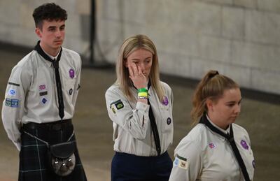 Mourners from the scouts react as they file past the coffin as they attend the lying-in-state of Queen Elizabeth II at the Palace of Westminster in London. EPA