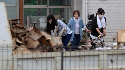 Residents move household items outside their homes in flood-hit area in Kawagoe, Saitama prefecture. AFP