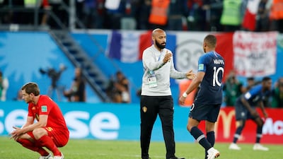 Belgium assistant coach, and former France striker, Thierry Henry congratulates France's Kylian Mbappe on his side's triumph. AP Photo