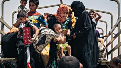 Civilians who recently fled territories formerly controlled by ISIL get off a truck at the Dibaga Camp for displaced people in Hajj Ali, northern Iraq. Alice Martins / AP Photo