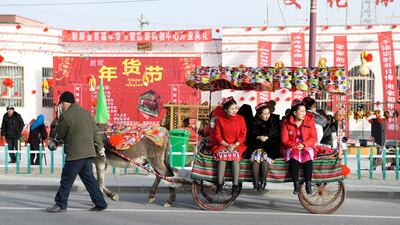 Passengers ride a donkey cart in Lopnur county, Xinjiang Uighur Autonomous Region, China. Reuters