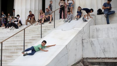 James Vongue, 8, slides down a marble structure next to stairs at the Lincoln Memorial in Washington. Reuters