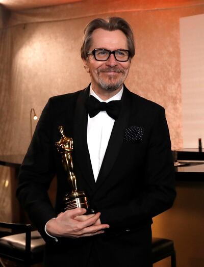 Gary Oldman holds his Oscar after getting it engraved at the 2018 awards. Reuters