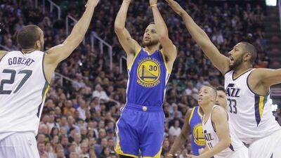Stephen Curry, centre, ended up with 30 points to help Golden State defeat Utah Jazz. Rick Bowmer / AP Photo