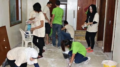 Students from the American University of Sharjah take part in renovation work at the orphanage.