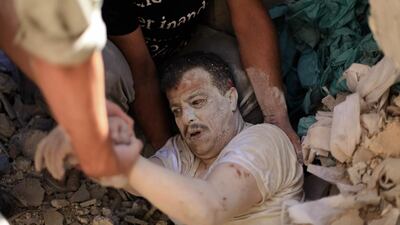 Members of the Syrian Civil Defence rescue a man under the rubble following a reported barrel-bomb attack by Syrian government forces in the Qadi Askar neighbourhood in Aleppo. Ahmed Deeb / AFP