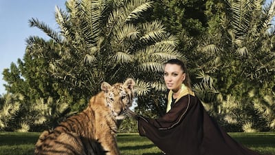 Roberta Mancino poses with a tiger as part of a campaign with the Emirates Park Zoo in Abu Dhabi. Massimiliano Haim / Caters News Agency