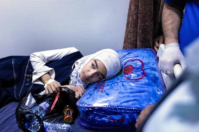 A girl is treated at a hospital in Basra after a lorry ploughed into a group of pupils leaving school. AFP