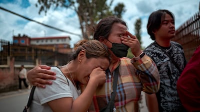 Women cry after receiving news of their loved ones outside Maharajgunj Medical Campus.