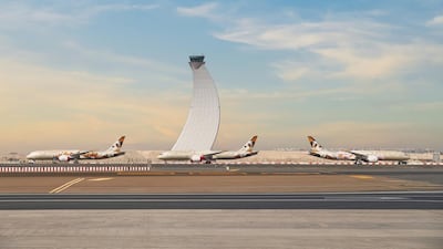 Etihad jets at Abu Dhabi International Airport in March last year after the UAE grounded passenger flights to prevent the spread of Covid-19 via air travel. Courtesy Etihad