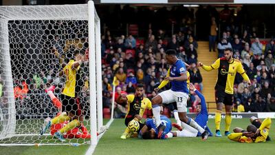 Everton's Yerry Mina pokes home their first goal at Watford. Reuters