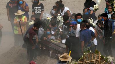 Relatives bury their loved one at the newly constructed Valle de Chalco Municipal Cemetery on the outskirts of Mexico City. AP Photo