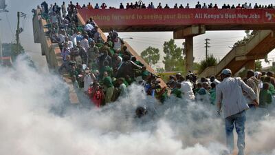 Dozens of children were caught in choking clouds of tear gas before being forced to shelter on a pedestrian bridge over the main road to escape the noxious fumes. Tony Karumba/AFP Photo